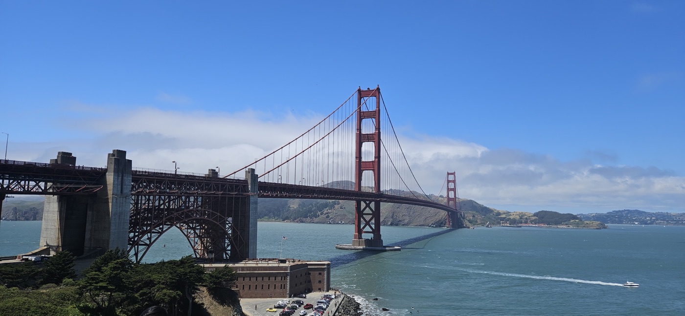 The Golden Gate Bridge with fog rolling over the far tower